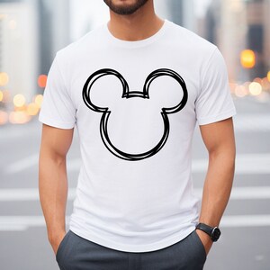 May include: White t-shirt with a black outline of Mickey Mouse's head.