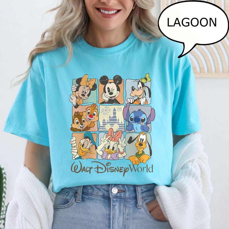 May include: A light blue t-shirt featuring a grid of Disney characters including Mickey Mouse, Minnie Mouse, Goofy, Donald Duck, and Stitch. The words "Walt Disney World" are printed below the grid.