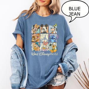 May include: Blue jean-colored t-shirt featuring a grid of Disney characters, including Mickey Mouse, Minnie Mouse, and Goofy. The shirt has the words "Walt Disney World" printed in a script font at the bottom.