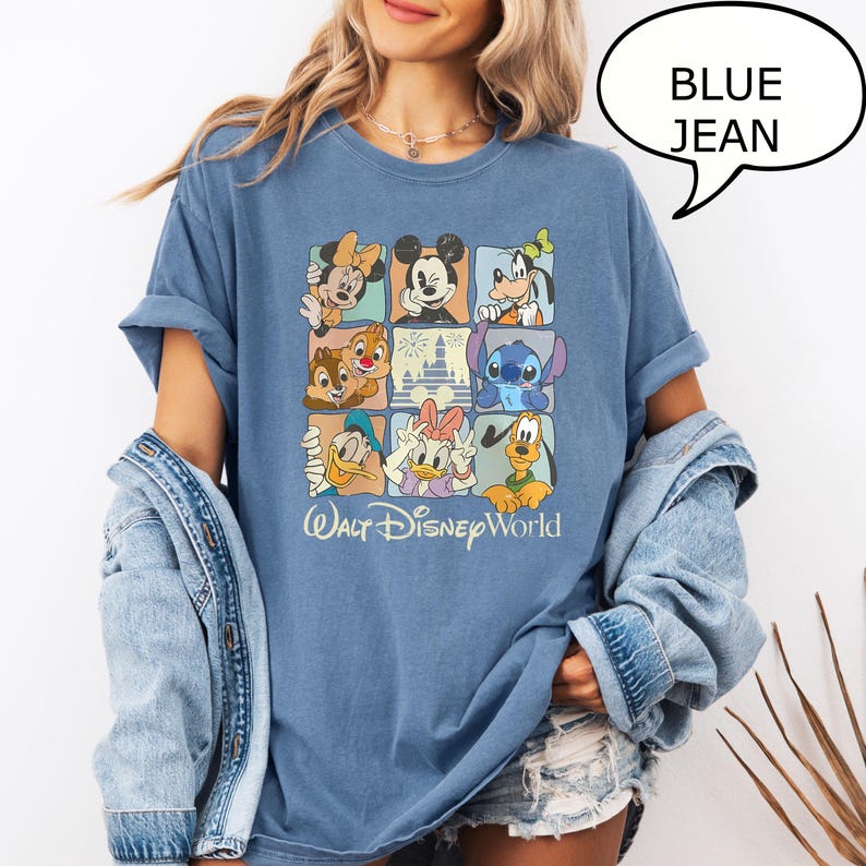 May include: Blue jean-colored t-shirt featuring a grid of Disney characters, including Mickey Mouse, Minnie Mouse, and Goofy. The shirt has the words "Walt Disney World" printed in a script font at the bottom.