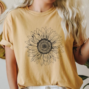 Tシャツ・カットソー [ AMONG ] A YELLOW FLOWER SEED LOGO T_WHITE niche.（ニッチ）の「niche.(ニッチ) Flower seeds Tシャツ