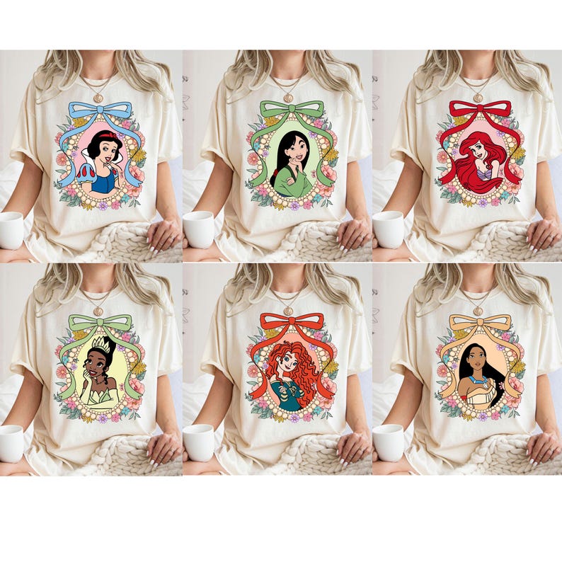 May include: Six white t-shirts with different Disney princess illustrations. Each shirt features a princess in a floral frame with a bow at the top. The princesses are Snow White, Mulan, Ariel, Tiana, Rapunzel, and Pocahontas.