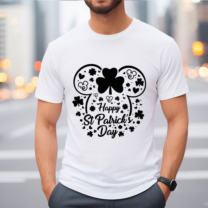 May include: White t-shirt with a black graphic of a Mickey Mouse head made of shamrocks and the text "Happy St. Patrick's Day".