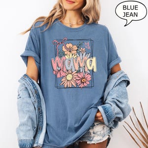 May include: A blue jean t-shirt with a floral design and the word "mama" in a colorful font.