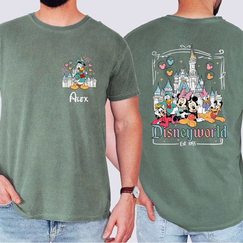 May include: Green t-shirt with a vintage-style graphic of Mickey Mouse, Minnie Mouse, Donald Duck, Goofy, and Pluto in front of Cinderella's Castle. The text "Disneyworld Est. 1965" is below the characters. The front of the shirt has a smaller graphic of Donald Duck in front of Cinderella's Castle with the name "Alex" below.