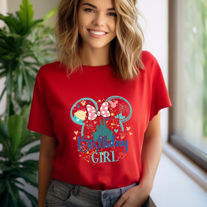 Puede incluir: Camiseta roja con un gr&aacute;fico de orejas de Mickey Mouse con un lazo rosa, un castillo y el texto "Birthday Girl".