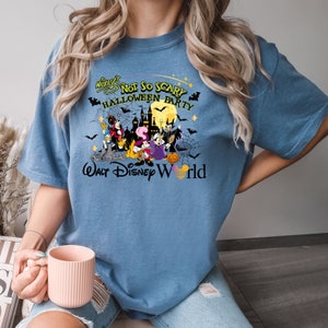 May include: A blue t-shirt with a graphic of Mickey Mouse and friends in Halloween costumes. The text "Mickey's Not So Scary Halloween Party" and "Walt Disney World" are printed on the shirt.