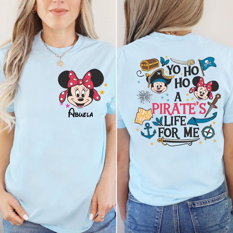 May include: Light blue t-shirt with a Mickey Mouse character on the front and a pirate themed design on the back. The back design includes the text "Yo Ho Ho A Pirate's Life For Me".