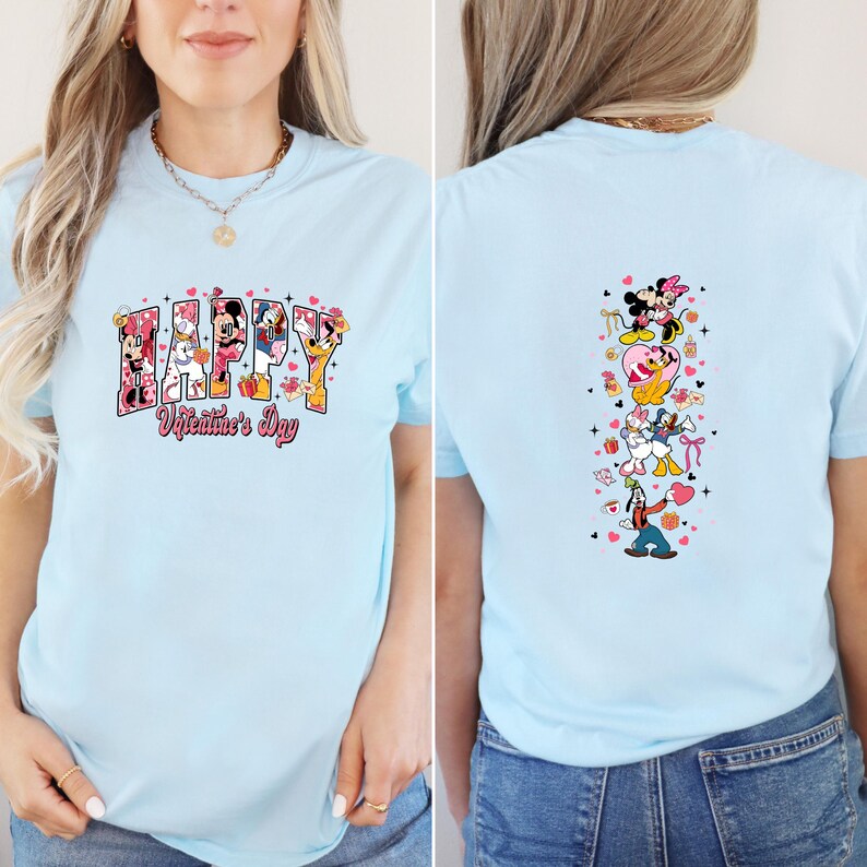 May include: Light blue t-shirt featuring the text "HAPPY Valentine's Day" with Disney characters. The back of the shirt has a vertical design of Disney characters. The shirt is made of a soft material.