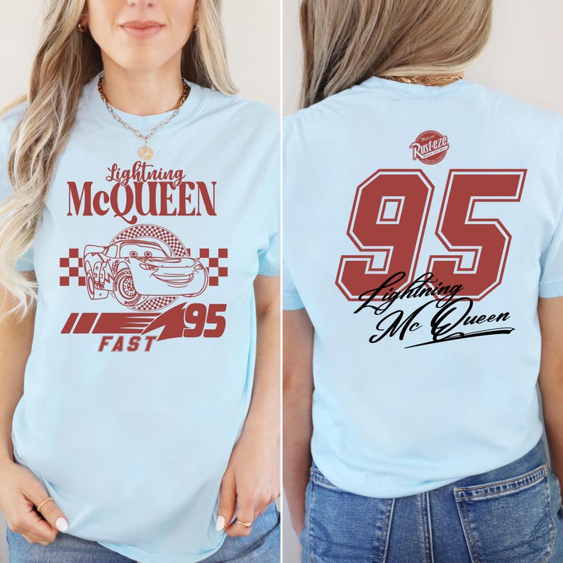 May include: Light blue t-shirt with a red cartoon race car and the text "Lightning McQueen" on the front. The back of the shirt has the number "95" in red with the text "Lightning McQueen" in black.