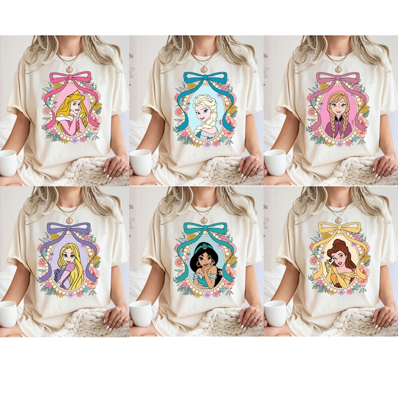 May include: Six cream-colored t-shirts with different Disney princess illustrations. Each shirt features a princess in a floral frame with a pink, blue, purple, teal, or yellow bow.
