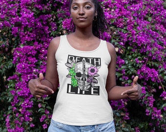 May include: White tank top with a black and white skull graphic with flowers and the text "DEATH BECOME LIFE".