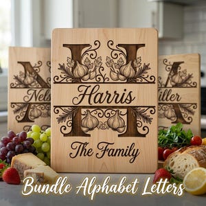 May include: A rectangular light-colored wooden cutting board featuring a laser-engraved large letter H, garlic bulb illustrations, and the text Harris The Family. Two additional wooden boards with similar engravings are visible in the background.