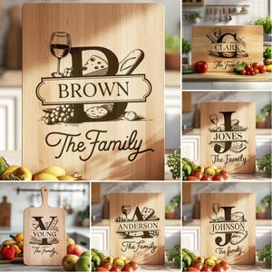 May include: A set of ten personalized wooden cutting boards with a design featuring a wine glass, cheese, bread, and a large initial letter. Each board has a family name and the words "The Family" engraved on it.
