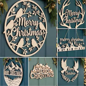 May include: A collection of wooden Christmas decorations. The decorations include a round sign with birds and the text "Merry Christmas", a sign with antlers, a sign with houses, a sign with mountains, a sign with a village, and a sign with doves.