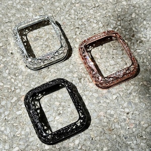 May include: Three decorative watch cases in silver, rose gold, and black with a diamond-like pattern. The cases are designed to fit a square-shaped watch face.