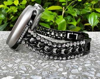 May include: A black chain watch band with clear rhinestones. The band is designed to fit a smartwatch.