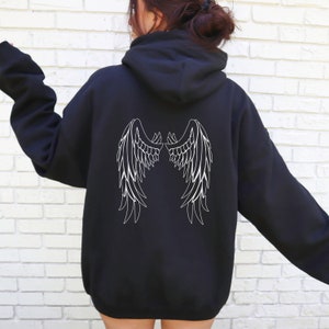May include: Black hooded sweatshirt with a white outline of angel wings on the back.