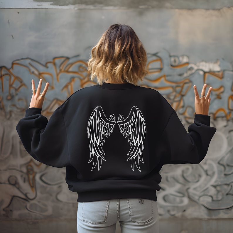 May include: Black sweatshirt with white angel wings printed on the back.