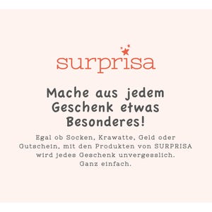 May include: A pink and white graphic with the text "surprisa" in red. The text below reads "Mache aus jedem Geschenk etwas Besonderes!" and "Egal ob Socken, Krawatte, Geld oder Gutschein, mit den Produkten von SURPRISA wird jedes Geschenk unvergesslich. Ganz einfach."