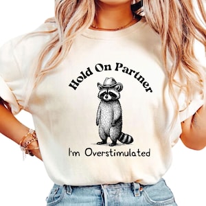 Hold On Partner I&#39;m Overstimulated Comfort Colors Shirt, Cowboy Racoon Shirt, Funny Meme Tee, Funny Racoon Shirt