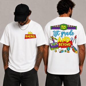 May include: A white t-shirt featuring a graphic on the front left chest that reads Ms. KNEBEL in yellow and red. The back displays the text To 1st grade AND BEYOND with colorful illustrations of school supplies, a globe, and a rocket ship.
