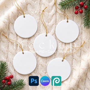 May include: Five blank white circular ceramic ornaments with gold hanging strings. The ornaments are arranged in a cluster. The text mockup Smart Object PSD + Canva Template is overlaid in the centre. The image includes Photoshop and Canva logos.