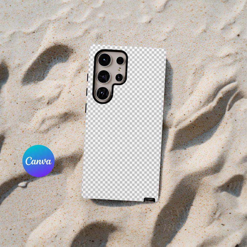 May include: A white phone case with a clear, checkered pattern and a black camera bump with three lenses. The case is lying on a sandy surface.