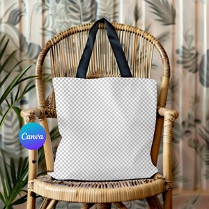 May include: A white tote bag with black handles sits on a wicker chair. The bag is blank and ready for customization.