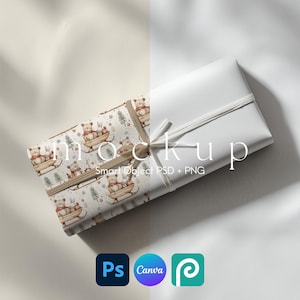May include: Two wrapped gifts, one with a white cover and the other with a patterned paper featuring bears and rabbits on sleds. The gifts are tied with a white string. The image includes the text "mockup" and icons for Photoshop, Canva, and Photopea.