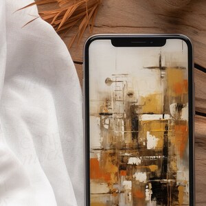Blank black smartphone on natural wood with soft white fabric and dried leaves, creating a warm, organic setting for mobile design presentations