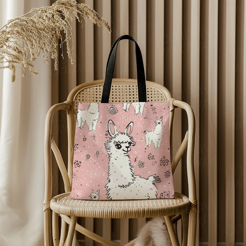 May include: A pink tote bag with a white llama design. The llama is surrounded by small pink flowers. The bag has black handles.
