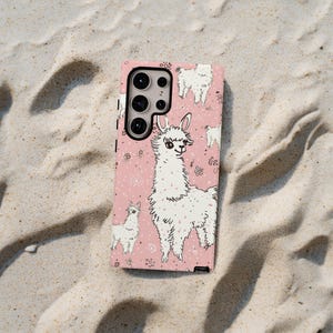 May include: A pink phone case with a white llama pattern. The case has a camera cutout and a black border.
