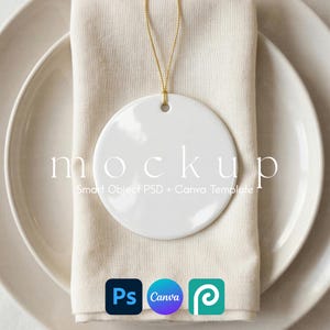 May include: A white circular ceramic ornament with a gold hanging string. The ornament features the text mockup Smart Object PSD + Canva Template. Below the ornament are three square icons representing Photoshop, Canva, and a design software.