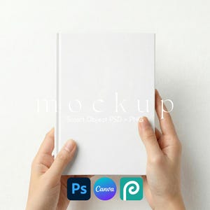 May include: A white book mockup held by hands. The book has a blank cover, with the word "mockup" and the text "Smart Object PSD + PNG" in the background. Icons for Photoshop, Canva, and a stylized "P" are at the bottom.