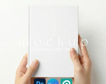 May include: A white book mockup held by hands. The book has a blank cover, with the word "mockup" and the text "Smart Object PSD + PNG" in the background. Icons for Photoshop, Canva, and a stylized "P" are at the bottom.