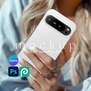 May include: White phone case mockup with a triple camera lens. The case is being held by a hand with rings. The text "mockup" and "Smart Object PSD + PNG" is visible on the case.