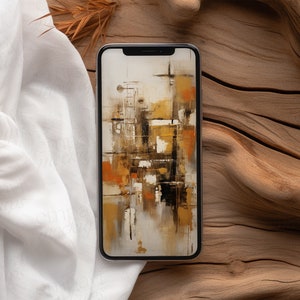 Blank black smartphone on natural wood with soft white fabric and dried leaves, creating a warm, organic setting for mobile design presentations