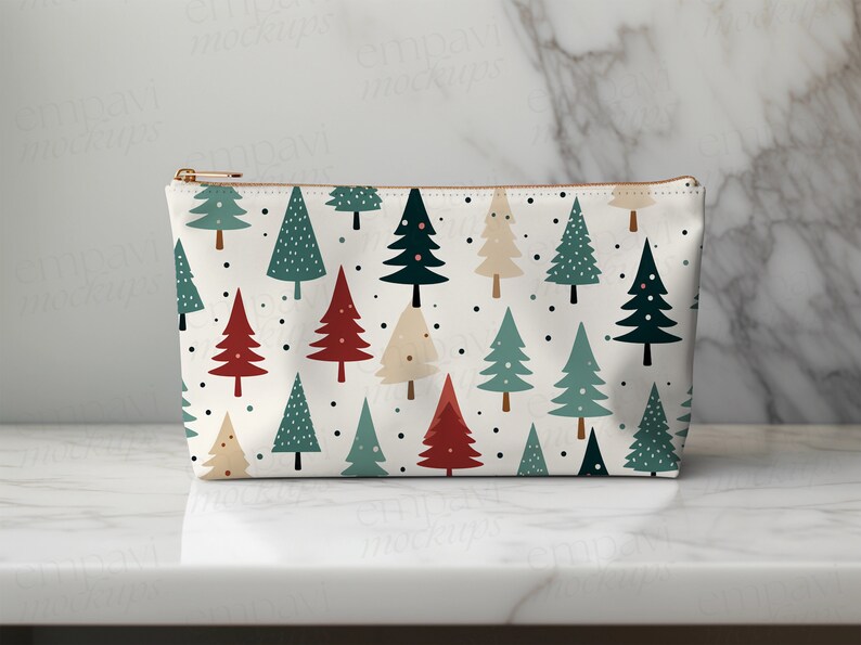 May include: A white zippered pouch with a repeating pattern of stylized Christmas trees in red, green, and cream. The trees have small black dots scattered around them.