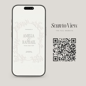 May include: A smartphone displaying a white wedding invitation with embossed floral borders and the text: THE WEDDING OF AMELIA & RAPHAEL, Saturday, August 10, 2027, Villa Balbiano, Lake Como, Italy. Next to it is a black QR code with Scan to View text.