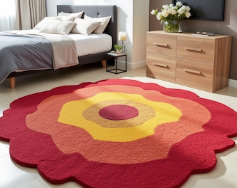May include: A round, multi-colored, flower-shaped rug with a red, orange, yellow, and brown color scheme. The rug has a concentric circle design with a red center circle.