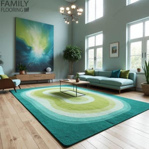 May include: A teal, green and white abstract patterned rug with a wavy design. The rug is in a living room with a light blue sofa, a coffee table and a large painting on the wall.