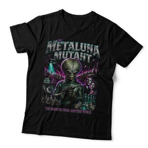 May include: A black short-sleeved t-shirt featuring a graphic print of The Metaluna Mutant. The design includes the text "THE METALUNA MUTANT" and "THE MONSTER FROM ANOTHER WORLD," along with illustrations of a large-headed alien, a flying saucer, and people.