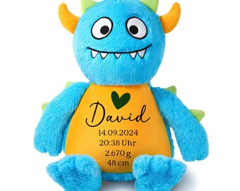 May include: A blue and yellow plush monster toy with a heart and the name "David" embroidered on its chest. The toy also includes the date "14.09.2024", time "20:38 Uhr", weight "2.670 g", and height "48 cm".