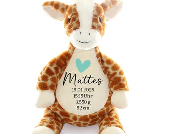May include: A plush giraffe toy with a light brown and white pattern. The giraffe has a light blue heart on its chest and is personalized with the name "Mattes", the date "15.01.2025", the time "15:15 Uhr", the weight "3.550 g", and the length "52 cm".