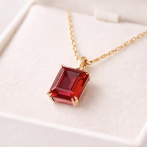 Halsband med hänge i rött smaragdslipat ädelsten, minimalistisk guldkedja, eleganta jubileumssmycken