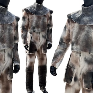 May include: A white and brown camouflage jumpsuit with a high collar and a large, wide collar. The jumpsuit has pockets on the legs and arms.