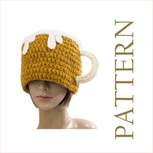 May include: A crocheted beer mug hat in brown and white. The hat is shaped like a beer mug with a handle and a foam top.
