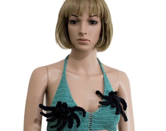 May include: A teal crochet halter top with black crocheted spider accents.