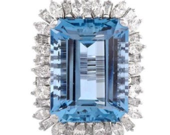 May include: A large, rectangular aquamarine gemstone ring set in white gold with a halo of smaller diamonds.